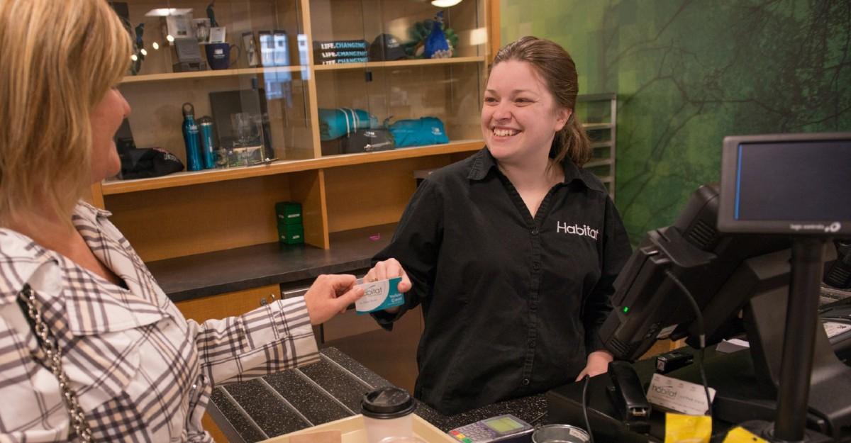 person handing cashier at cafeteria card