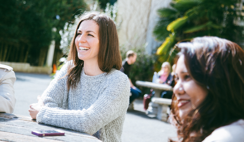 Two people outside smiling